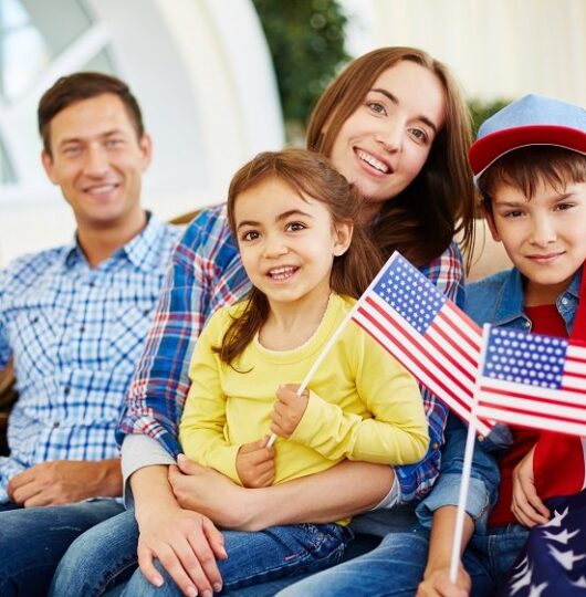 Family of patriots with USA flags on Independence Day